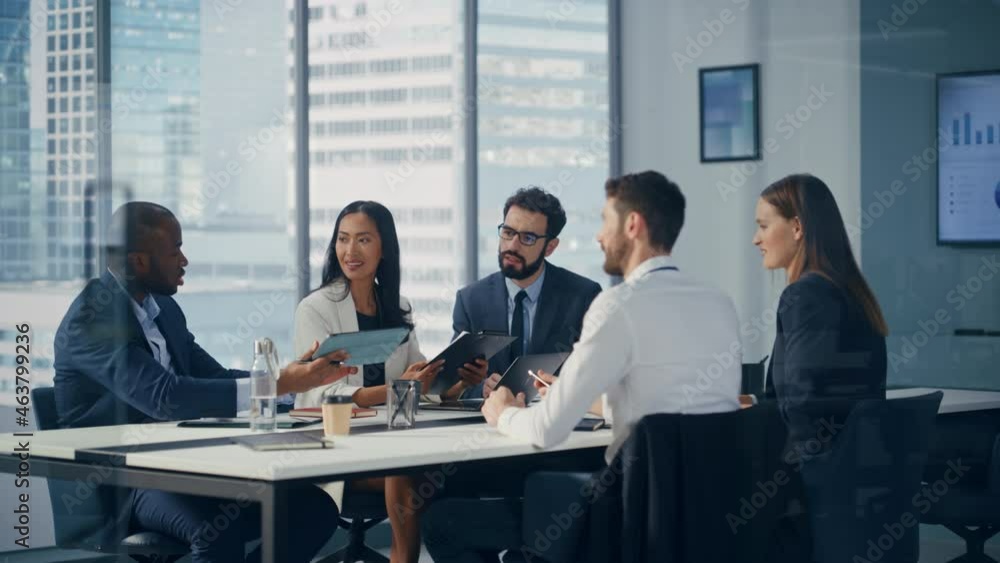 Modern Multi-Ethnic Office Conference Room Meeting: Diverse Team of Young Ambitious Top Managers, Executives Talk, Use Tablet. Smiling Businesspeople Discuss Investment in Digital e-Commerce Startup