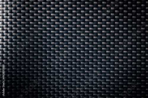 Mesh black texture. Dark polyester fiber material for sport cloth or abstract weave background. Synthetic pattern for backpacks and sports equipment.
