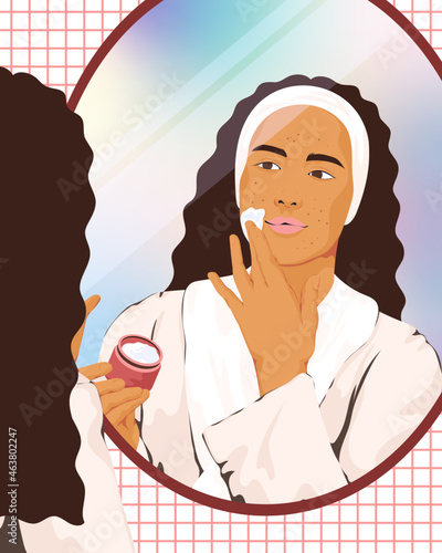 Woman looking in mirror applying moisturiser 