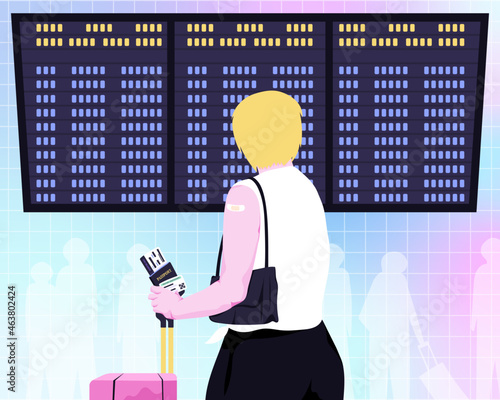Vaccinated passenger looking at airport flight information screen