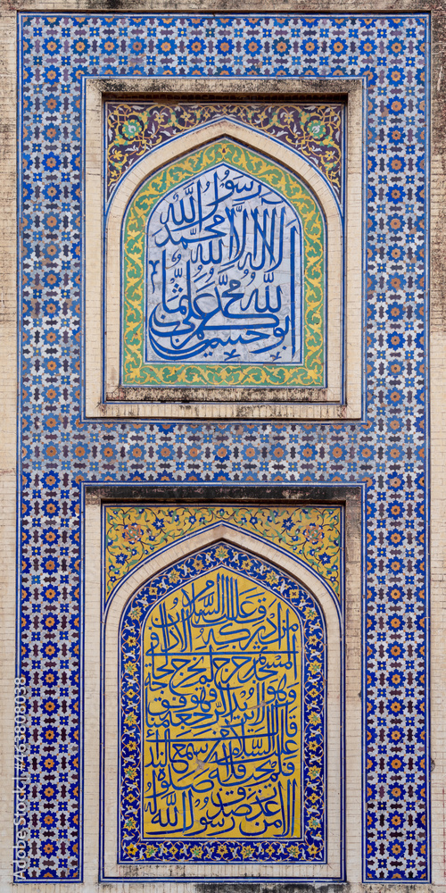 Colorful kashi-kari or faience tile mosaic panel with Quran inscriptions on ancient mughal era Wazir Khan mosque in the walled city of Lahore, Punjab, Pakistan