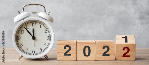 Happy New Year with vintage alarm clock and flipping 2021 change to 2022 block. Christmas, New Start, Resolution, countdown, Goals, Plan, Action and Motivation Concept