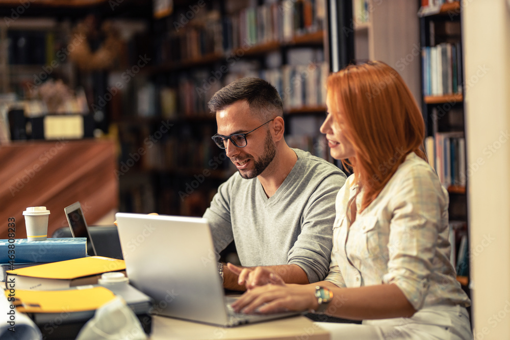 Two students study in the college library.
Two students study in the college library.