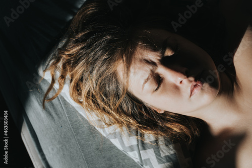 Portrait of a sleeping caucasian woman in the morning sun.
