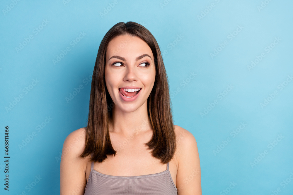 Portrait of attractive curious cheerful girl licking lip looking aside copy space seduction isolated over bright blue color background Portrait of attractive curious cheerful girl licking lip looking aside copy space seduction isolated over bright blue color background