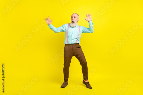 Full length body size photo elder man amazed with opened mouth chilling on weekend isolated bright yellow color background photo