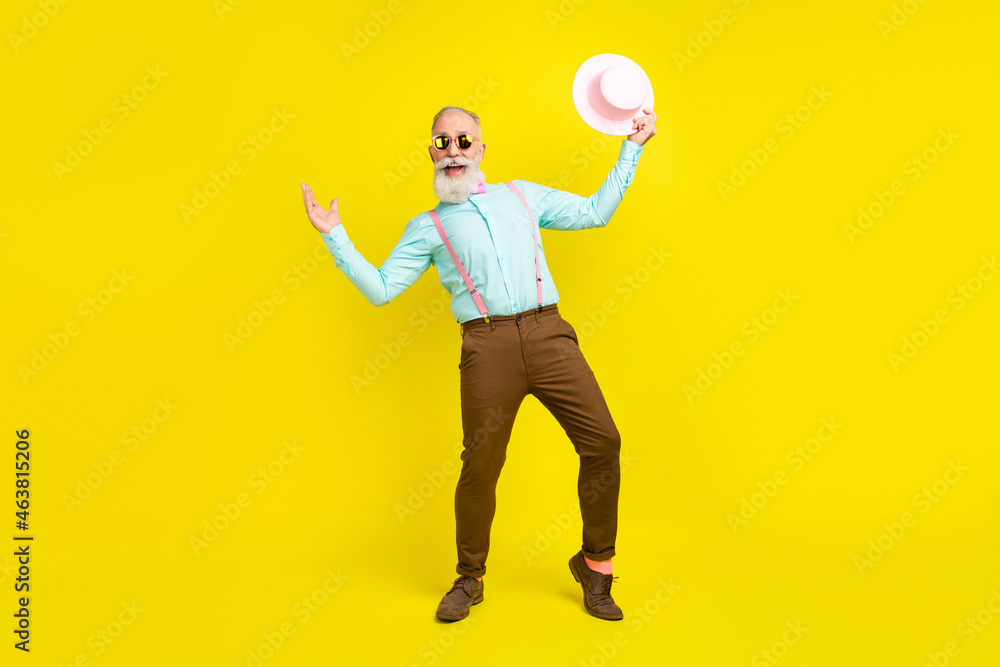 Full length body size photo senior man in sunglass dancing inviting to party smiling isolated vivid yellow color background Full length body size photo senior man in sunglass dancing inviting to party smiling isolated vivid yellow color background