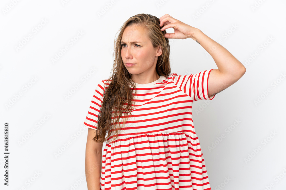 Young caucasian woman isolated on white background having doubts while scratching head Young caucasian woman isolated on white background having doubts while scratching head