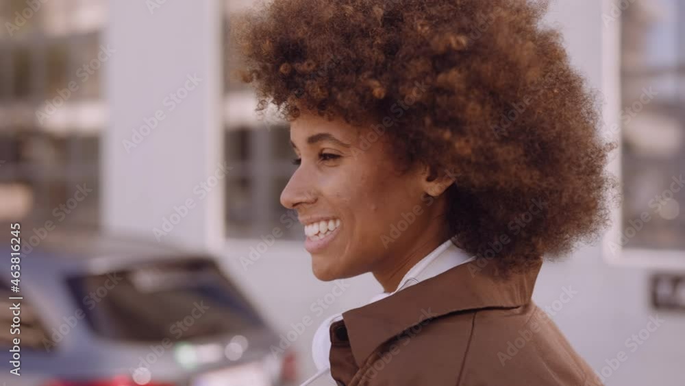 Woman With Afro Walking Down Street In City Woman With Afro Walking Down Street In City