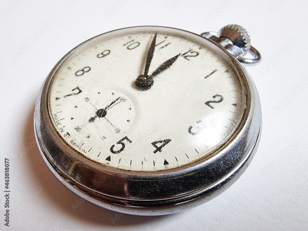 Vintage old pocket watch on white background.