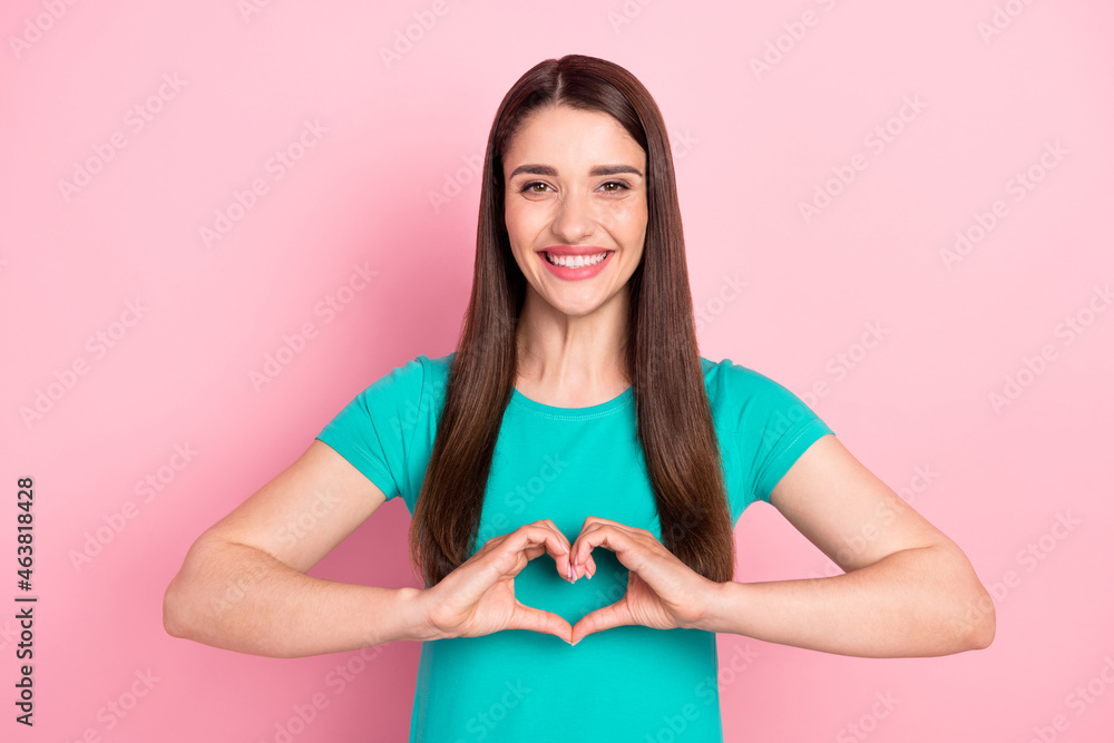 Photo of young woman happy positive smile show fingers heart symbol love romance isolated over pink color background