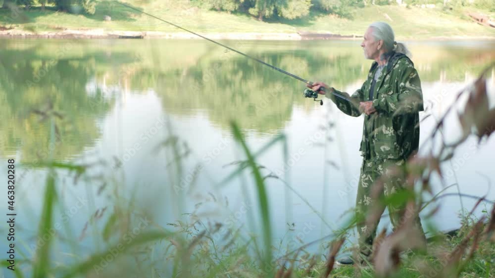 senior concept. The pensioner fishes on the river in his spare time. A useful hobby, outdoor activities in old age. copy space. dawn senior concept. The pensioner fishes on the river in his spare time. A useful hobby, outdoor activities in old age. copy space. dawn