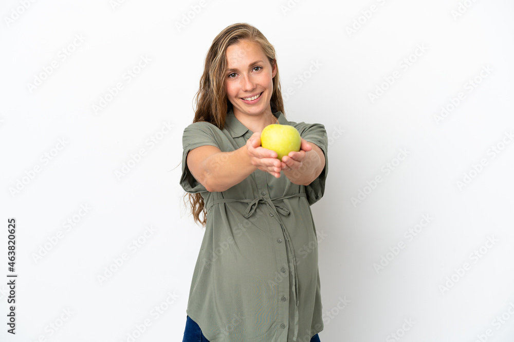 Young caucasian woman isolated on white background pregnant and holding an apple Young caucasian woman isolated on white background pregnant and holding an apple