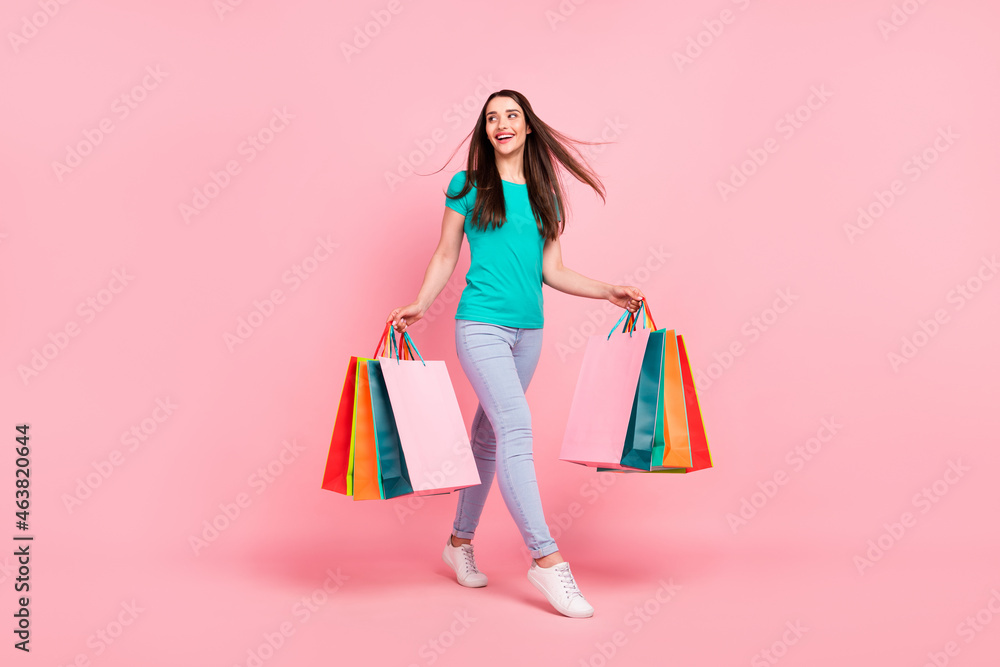 Full length profile side photo of young woman happy positive smile walk buy shop discount isolated over pastel color background
