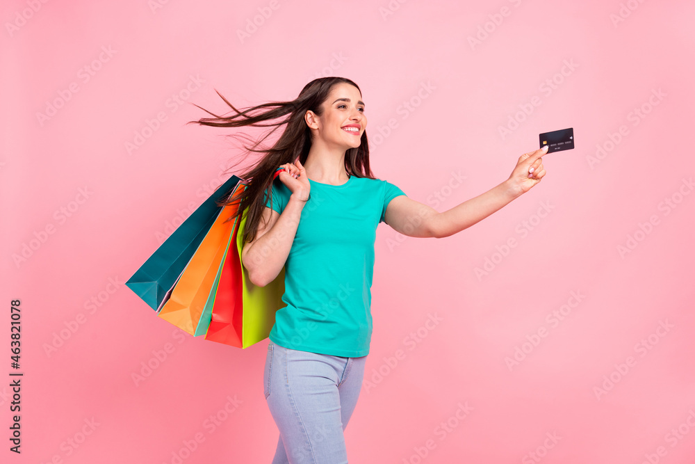 Profile side photo of young woman happy positive smile shop pay credit card bags isolated over pastel color background Profile side photo of young woman happy positive smile shop pay credit card bags isolated over pastel color background