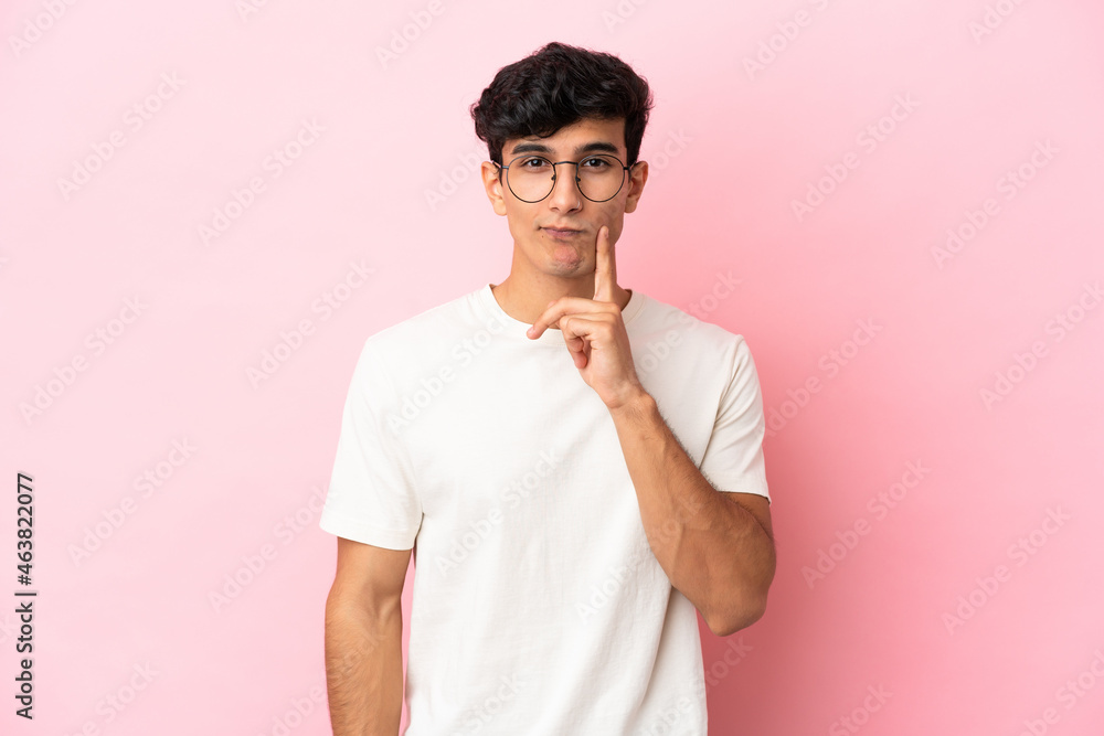 Young Argentinian man isolated on pink background and thinking Young Argentinian man isolated on pink background and thinking