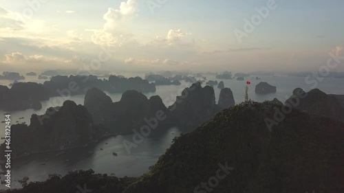 Limestone mountain islands covered with green tropical forests surrounded by water of sea aerial view Ha Long Bay Vietnam