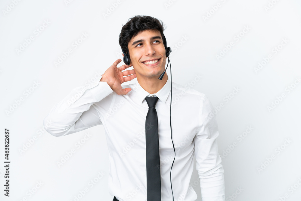 Telemarketer man working with a headset isolated on white background thinking an idea Telemarketer man working with a headset isolated on white background thinking an idea