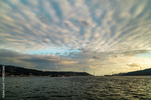 fisherman fishing boats on Bosporus Istanbul on a Foggy sunrise. Rainy clouds and dark weather