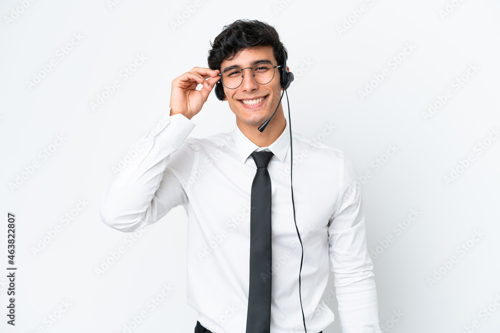 Telemarketer man working with a headset isolated on white background with glasses and happy Telemarketer man working with a headset isolated on white background with glasses and happy