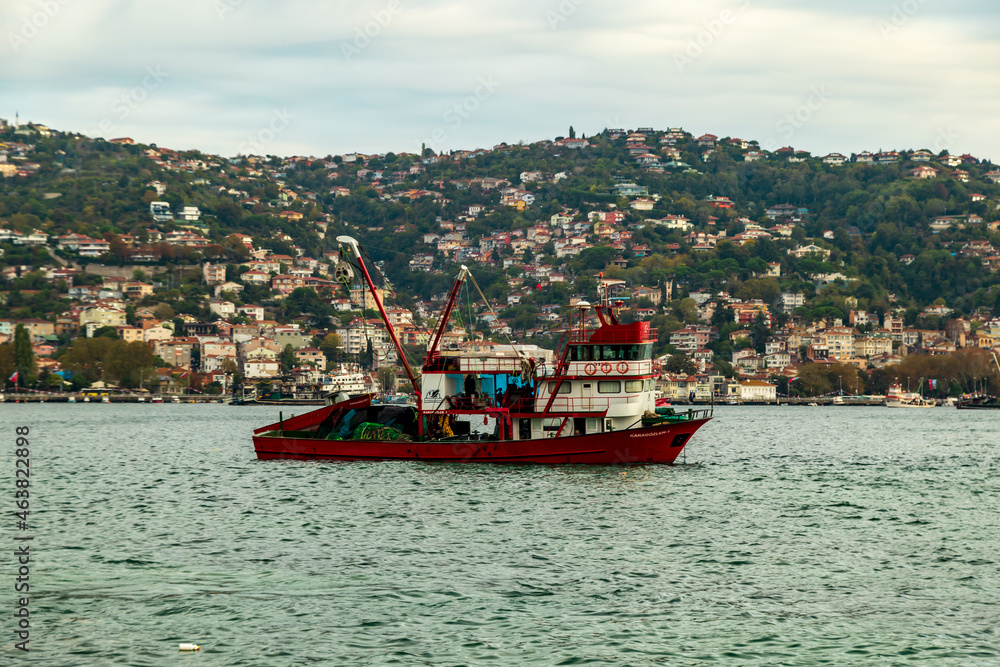 fisherman fishing boats on Bosporus Istanbul on a Foggy sunrise. Rainy clouds and dark weather