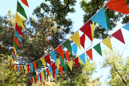 Colorful bunting flags in park. Party decor photo