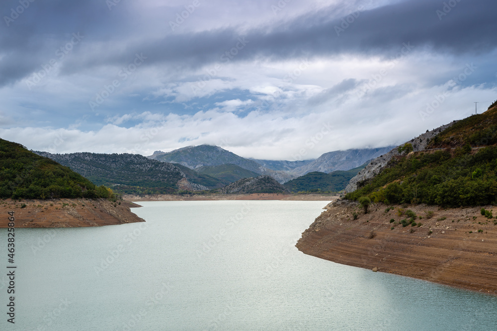 Landscape of Barrios de Luna Reservoir, mountains and cloudy sky. Province of León, Spain.
