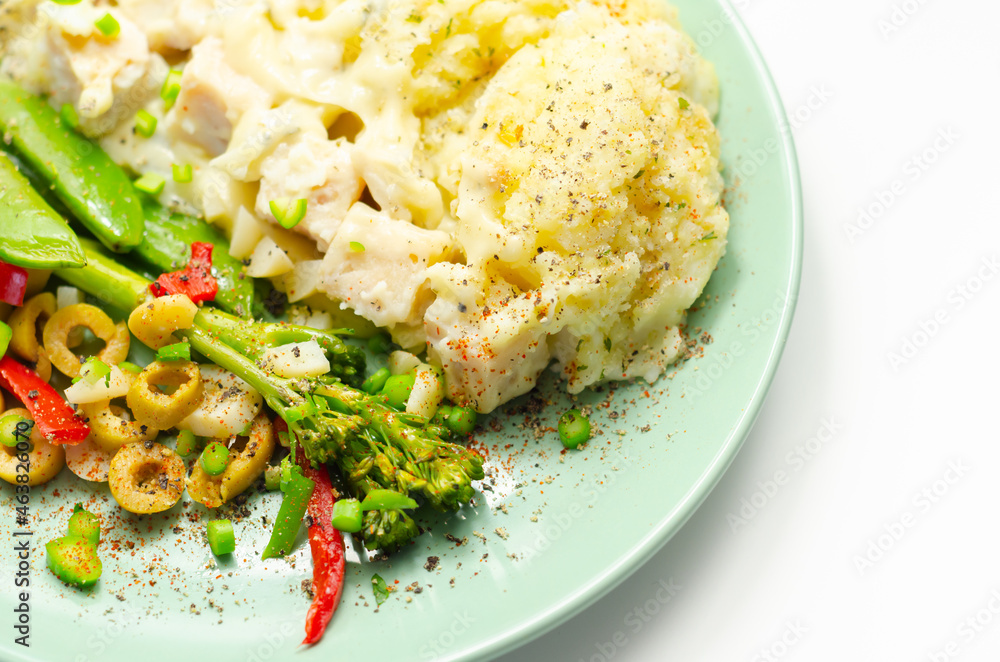 Tender pieces of smoked haddock and pollock in a creamy cheese sauce sat beneath buttery mash served with vegetables