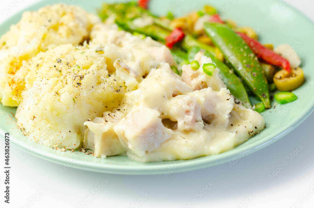 Tender pieces of smoked haddock and pollock in a creamy cheese sauce sat beneath buttery mash served with vegetables Tender pieces of smoked haddock and pollock in a creamy cheese sauce sat beneath buttery mash served with vegetables