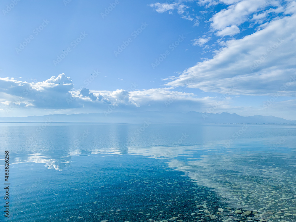 clouds reflection on the lake surface, natural colors, blue background clouds reflection on the lake surface, natural colors, blue background
