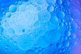 Water in oil in abstract style on blue background. blue liquid splash. Golden yellow bubble oil abstract background.