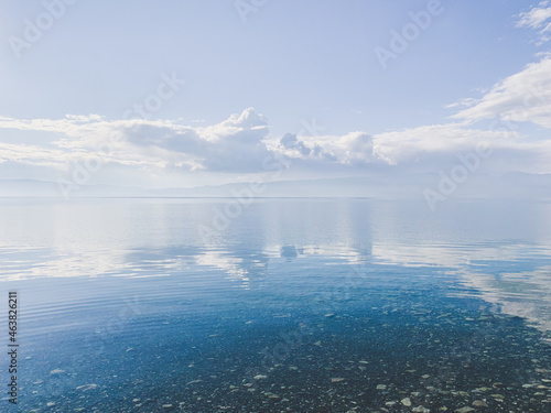 clouds reflection on the lake surface  natural colors  blue background
