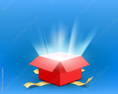 Red open gift box with rays of light from the inside