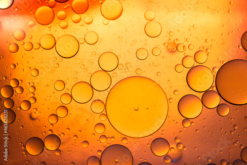 Water in oil in abstract style on blue background. blue liquid splash. Golden yellow bubble oil abstract background.