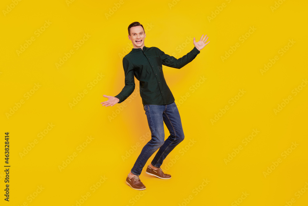 Full body profile side photo of young handsome man have fun fooling playful isolated over yellow color background