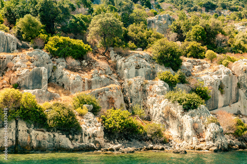 View of the northern side of the island of Kekova where the ruins of the partially flooded ancient cities of Dolichiste, Aperlaia, Teimussa and Simena are located. Turkey. Boat trip
