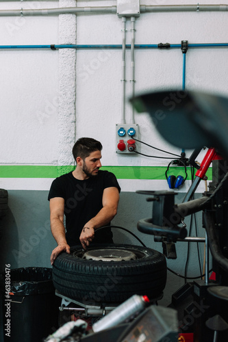 Car mechanic in a workshop working at car