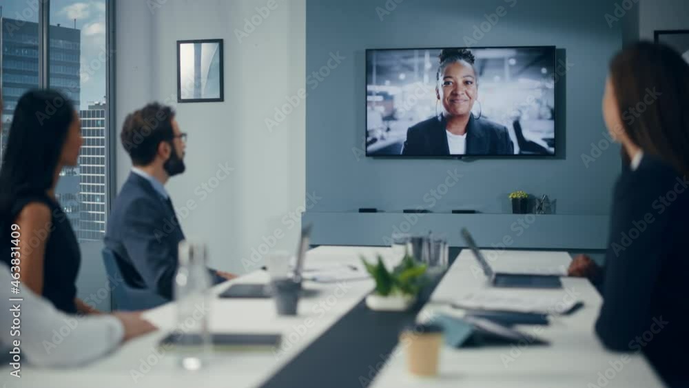 Video Conference Call in Office Boardroom Meeting Room: Black Female Executive Director Talks with Group of Entrepreneurs, Managers, Investors. Businesspeople Discuss e-Commerce Investment Strategy Video Conference Call in Office Boardroom Meeting Room: Black Female Executive Director Talks with Group of Entrepreneurs, Managers, Investors. Businesspeople Discuss e-Commerce Investment Strategy