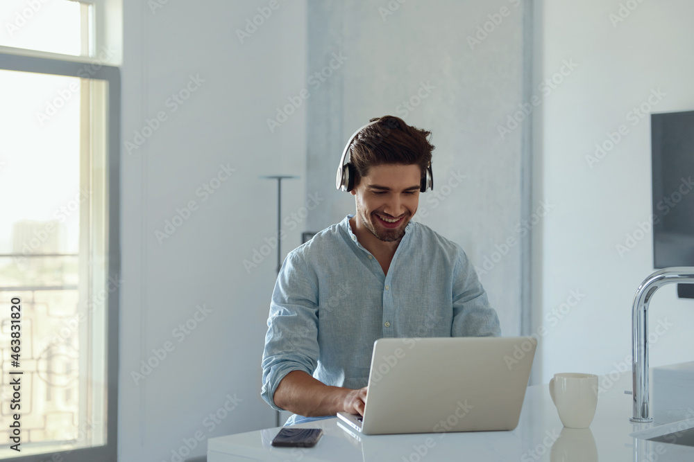 Man working remotely with laptop computer at home Man working remotely with laptop computer at home