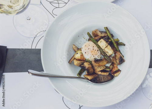 gourmet plate with sautéed mushrooms, asparagus, chios mastel (cheese), poached egg and truffle oil photo