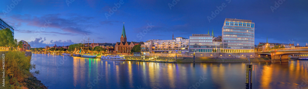 Panorama view of  harbour along the Schlachte Embankment and  Martinianleger by Bremen. View of Bremen riverside, Weser river, Schlachte promenade by evening. Skyline from Bremen with St. Martini. - obrazy, fototapety, plakaty 
