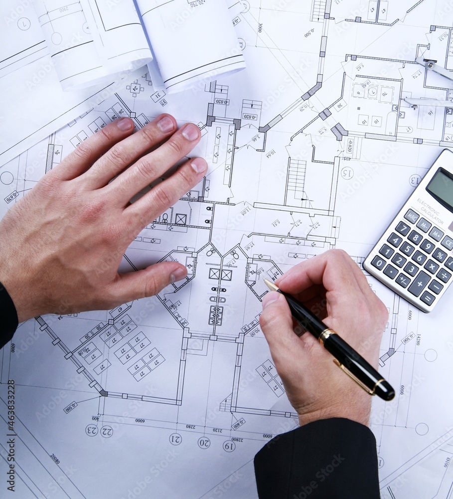 Architect working on a blueprint Architect working on a blueprint