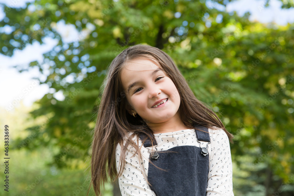 laughing little girl plays in the park
laughing little girl plays in the park