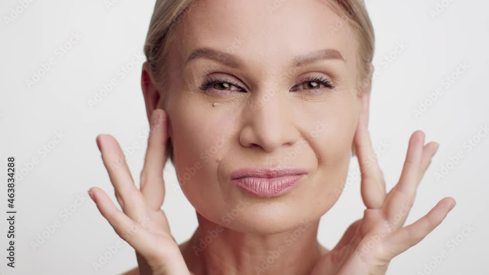 Face Lifting Concept. Beautiful Middle Aged Woman Making Revitalizing Facial Massage Face Lifting Concept. Beautiful Middle Aged Woman Making Revitalizing Facial Massage
