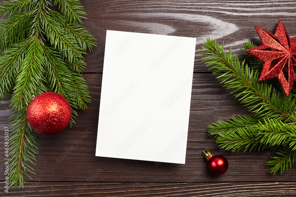 Christmas or New Year greeting card mockup with red festive decorations and fir tree branches Christmas or New Year greeting card mockup with red festive decorations and fir tree branches