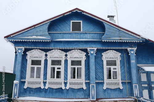 Vintage wooden rural house in Dunilovo village in Ivanovo region, Russia. Building facade; ornamental windows with carved frames. Russian traditional national folk style in architecture. Countryside photo