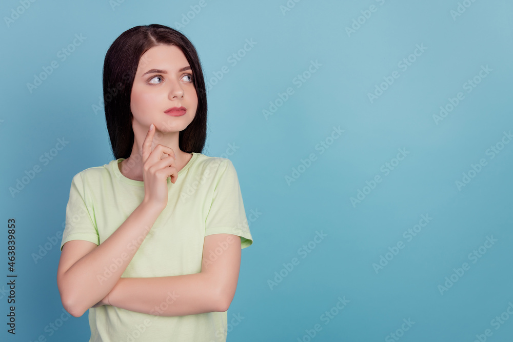 Photo of young minded girl fingers touch chin think look empty space idea isolated on turquoise color background Photo of young minded girl fingers touch chin think look empty space idea isolated on turquoise color background