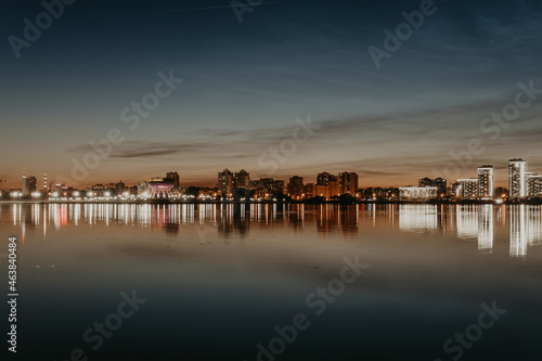 City night lights. Kazan embankment. New residential complexes. Reflection on the surface of the water. Long-term exposure.