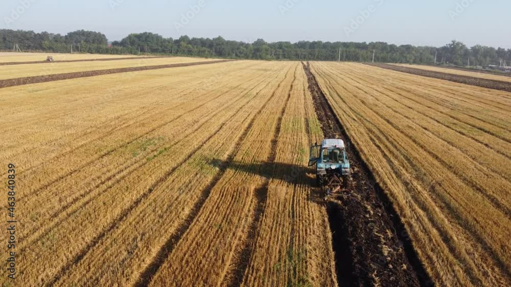 farm tractor plows the field and prepares for sowing farm tractor plows the field and prepares for sowing