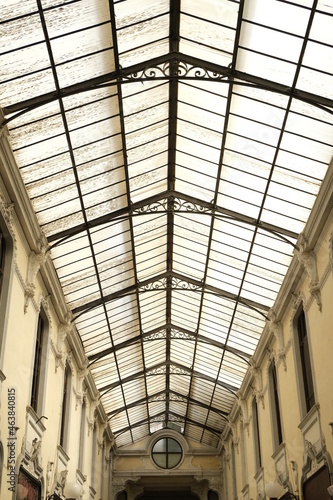Glass roof. Ancient commercial gallery of Alessandria.Glass roof with gable roof of a gallery with shops in the center of the Piedmontese city. Alessandria, Piedmont, Italy.